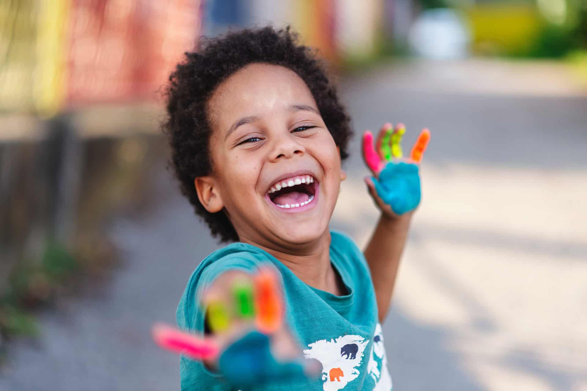 Happy young person with painted hands