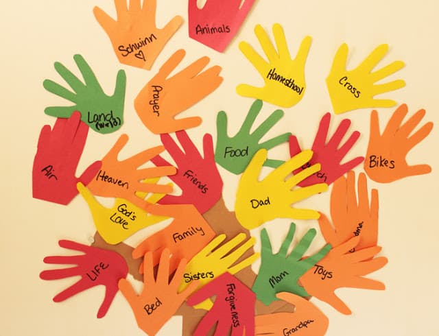 paper in the shape of hands with things that people are thankful for