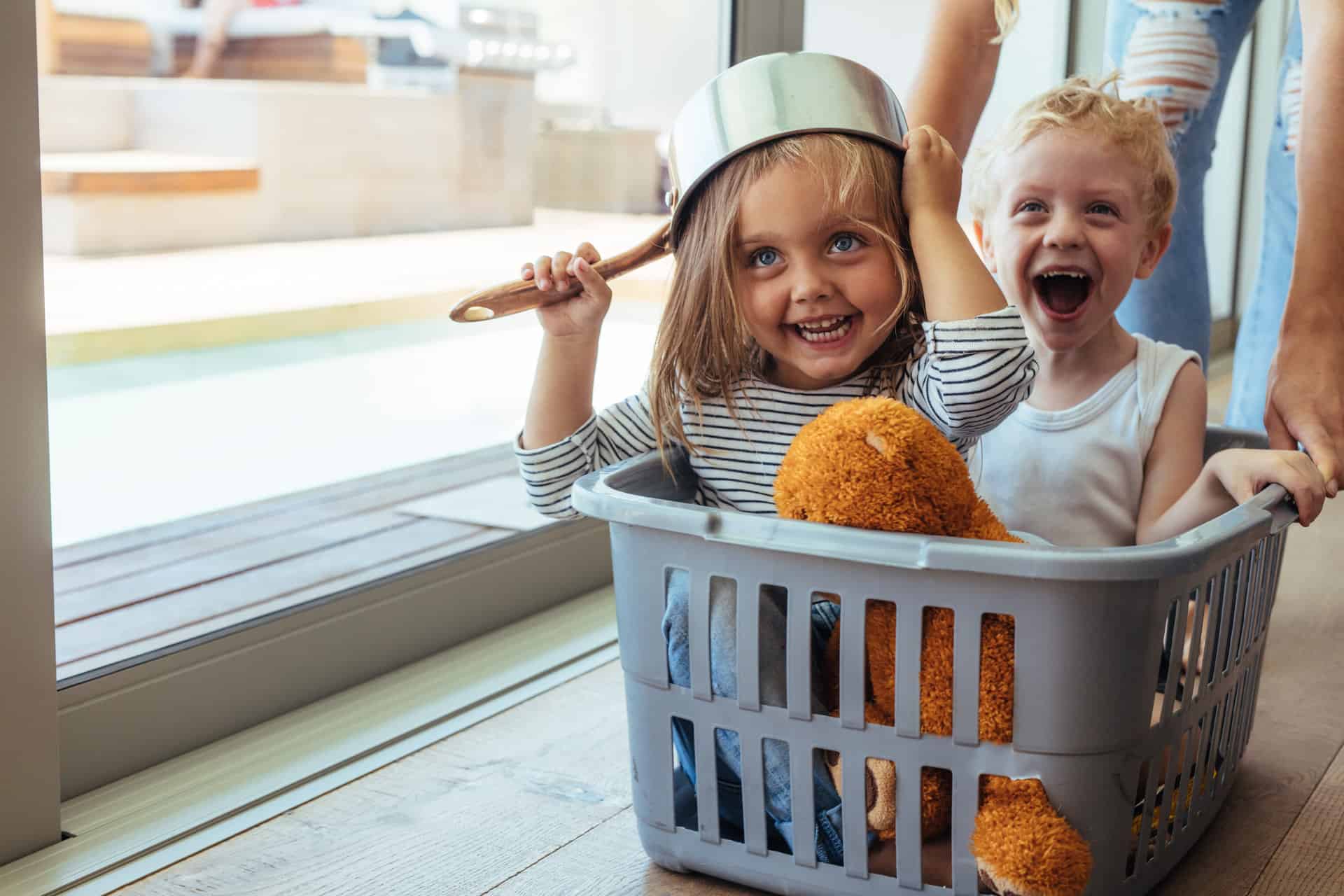 Kids playing in a laundry basket