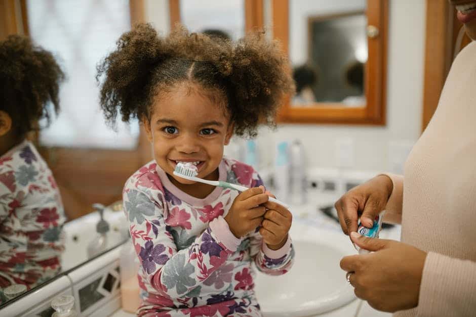 A child brushing teeth after visiting her pediatric dentist in Utah.